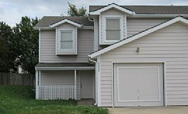 The Living Room Has a Large Brick Wood-Burning Fireplace in Overland Park, KS