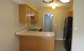 The Living Room Has a Large Brick Wood-Burning Fireplace in Overland Park, KS (Photo 2 of 6)