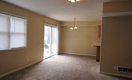 The Living Room Has a Large Brick Wood-Burning Fireplace in Overland Park, KS (Photo 3 of 6)