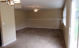 The Living Room Has a Large Brick Wood-Burning Fireplace in Overland Park, KS (Photo 4 of 6)