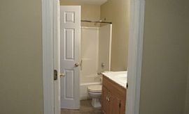 The Living Room Has a Large Brick Wood-Burning Fireplace in Overland Park, KS (Photo 5 of 6)