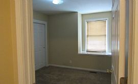 The Living Room Has a Large Brick Wood-Burning Fireplace in Overland Park, KS (Photo 6 of 6)