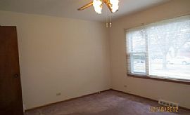 This Single Story Home Glistens with Fresh Paint and Hardwood F in Aurora, IL (Photo 5 of 6)