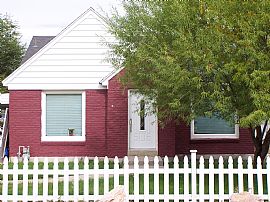 Red Brick House with White Picket Fence in Provo, UT