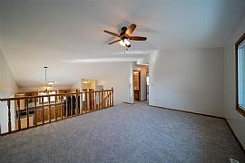 Enjoy The Morning Sunshine in The Large Upper Level Living Room in Sioux Falls, SD (Photo 5 of 6)